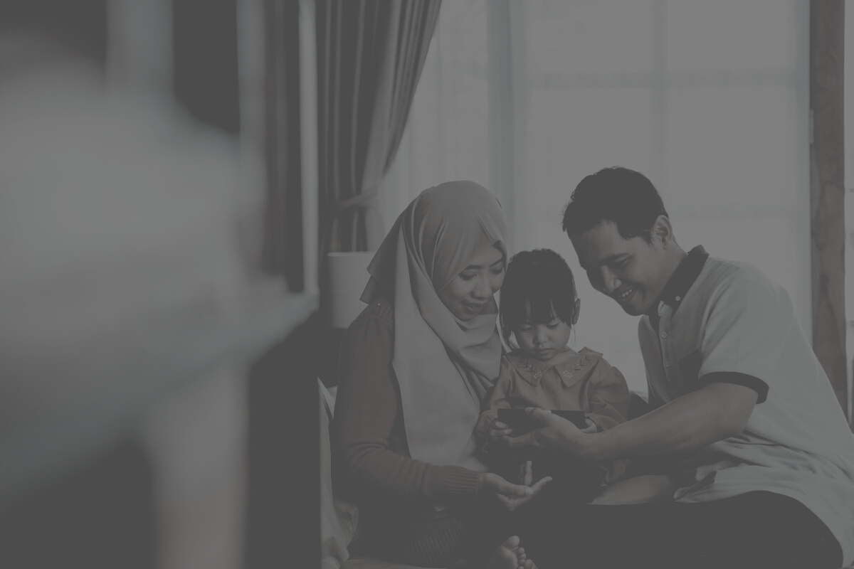 Asian Muslim Family Together Watching a Smartphone Screen